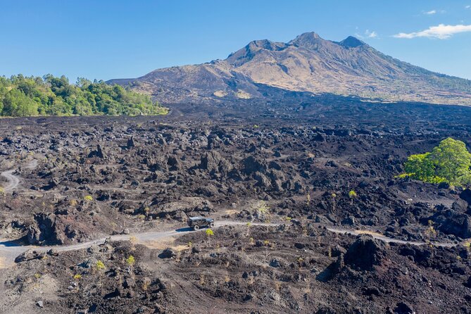 Kintamani Black Lava Sunrise Jeep Adventure with Temple in Bali - Stop 1: Gunung Batur Kintamani in a jeep over black lava terrain